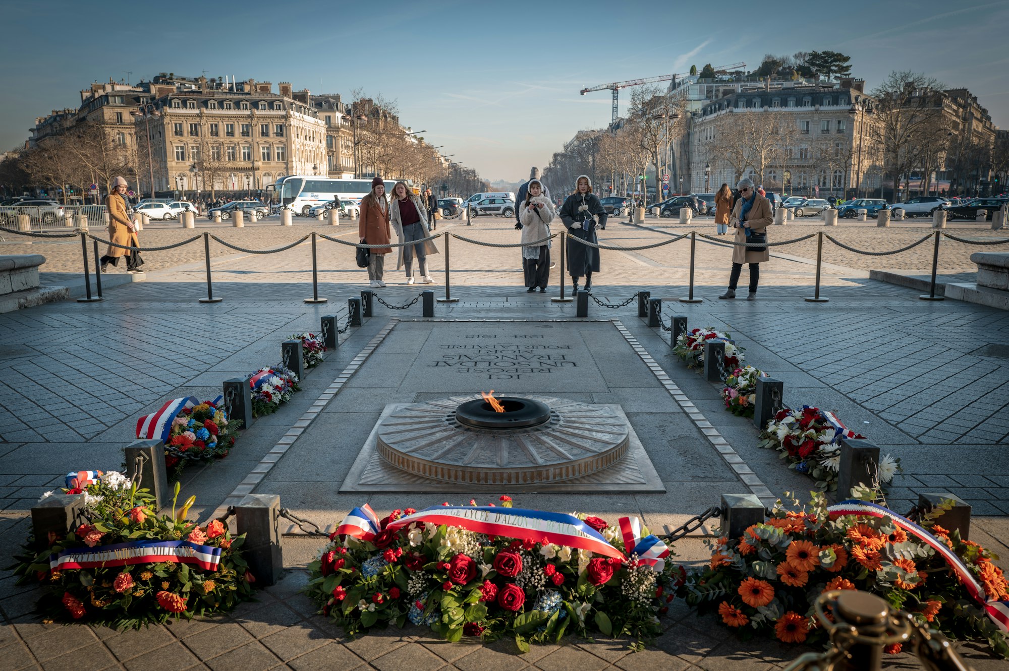 A group of people standing around a war memorial. Photo by Sung Jin Cho on Unsplash