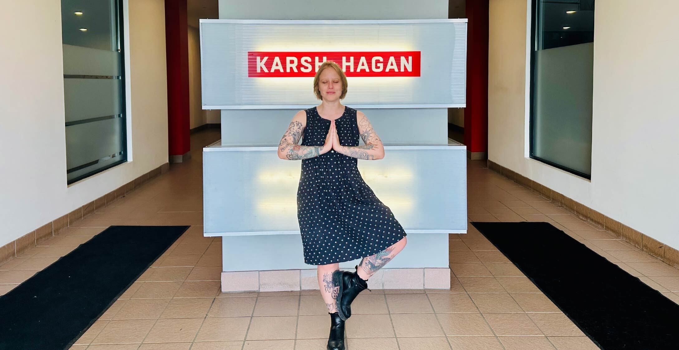 Avery Anderson in yoga pose outside Karsh Hagan office, blending mindfulness with creativity.