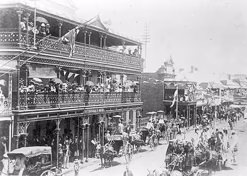 black and white photo of beardy street procession with horses and people from 1901 