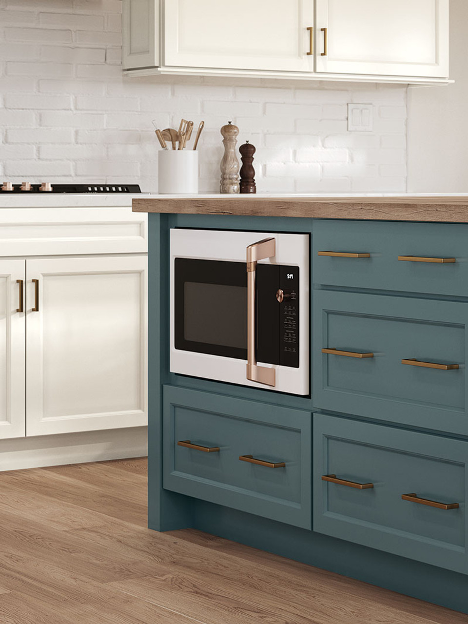 A teal kitchen island with wooden countertop and a microwave cabinet.