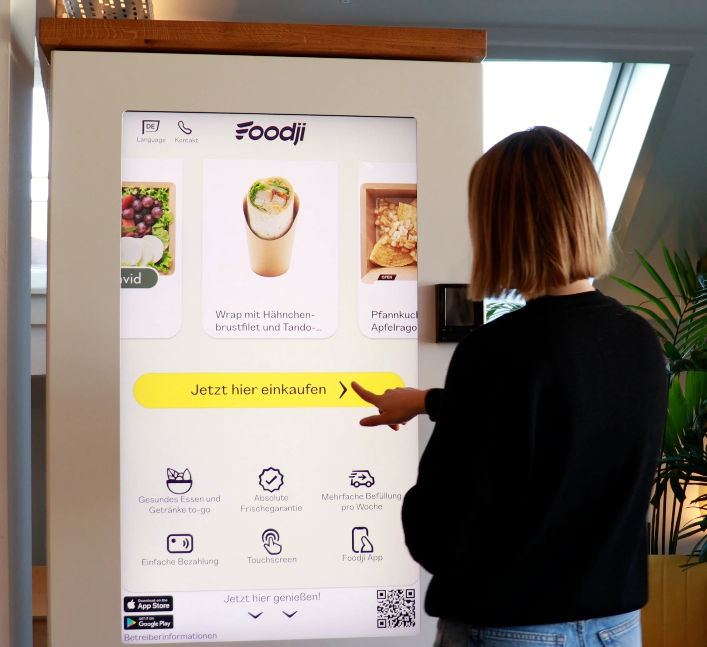 Frau kauft am Foodji Bistro ein