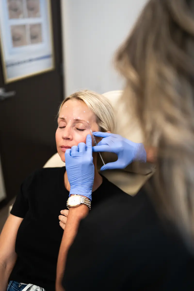 Injector assessing a client's expression lines before Botox® in Westminster, CO