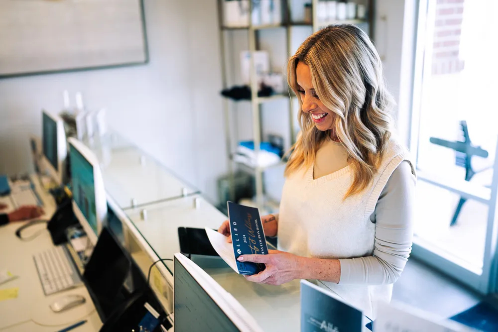Client paying at the front desk of Allied Medical Aesthetics