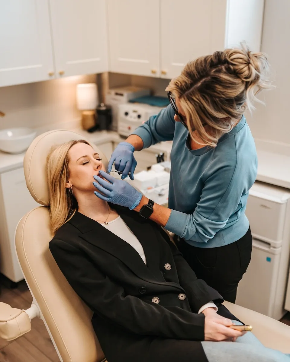 Injector assessing a client's expression lines before a Botox® treatment