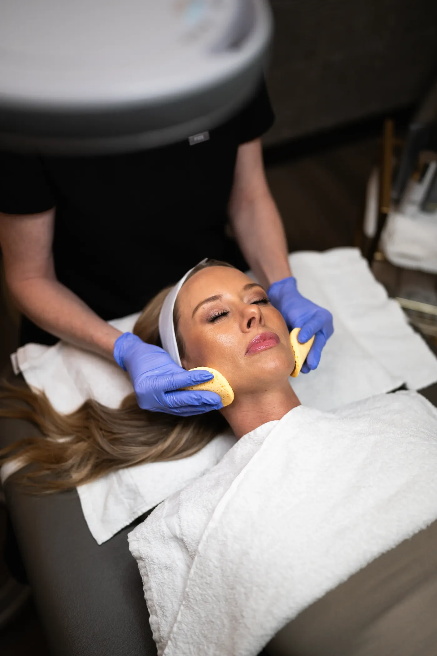 First-time client relaxing during a facial treatment at new patient pricing in Westminster, CO