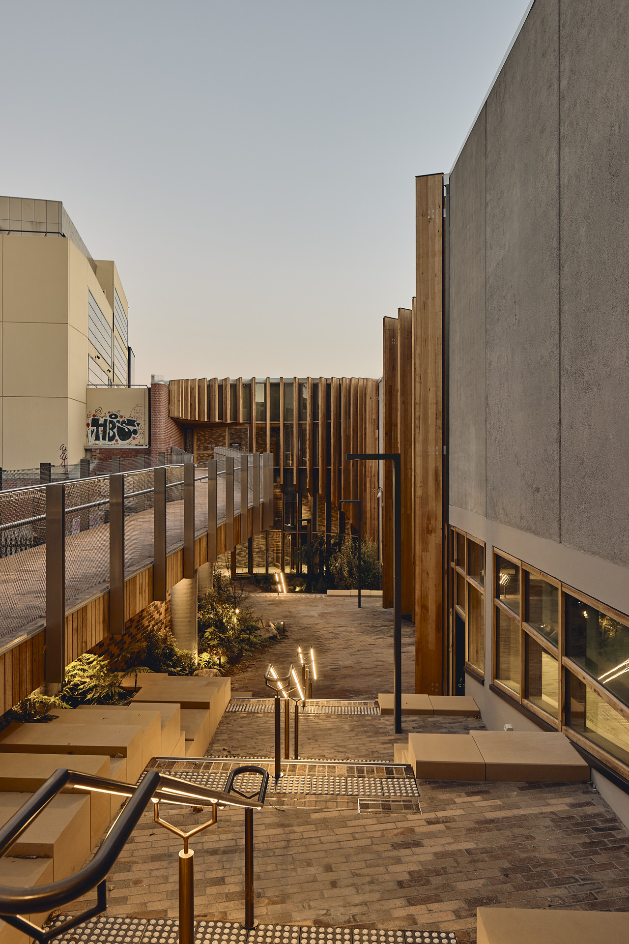 Timber fins beside glazing along a stepped pedestrian route at The Forest.