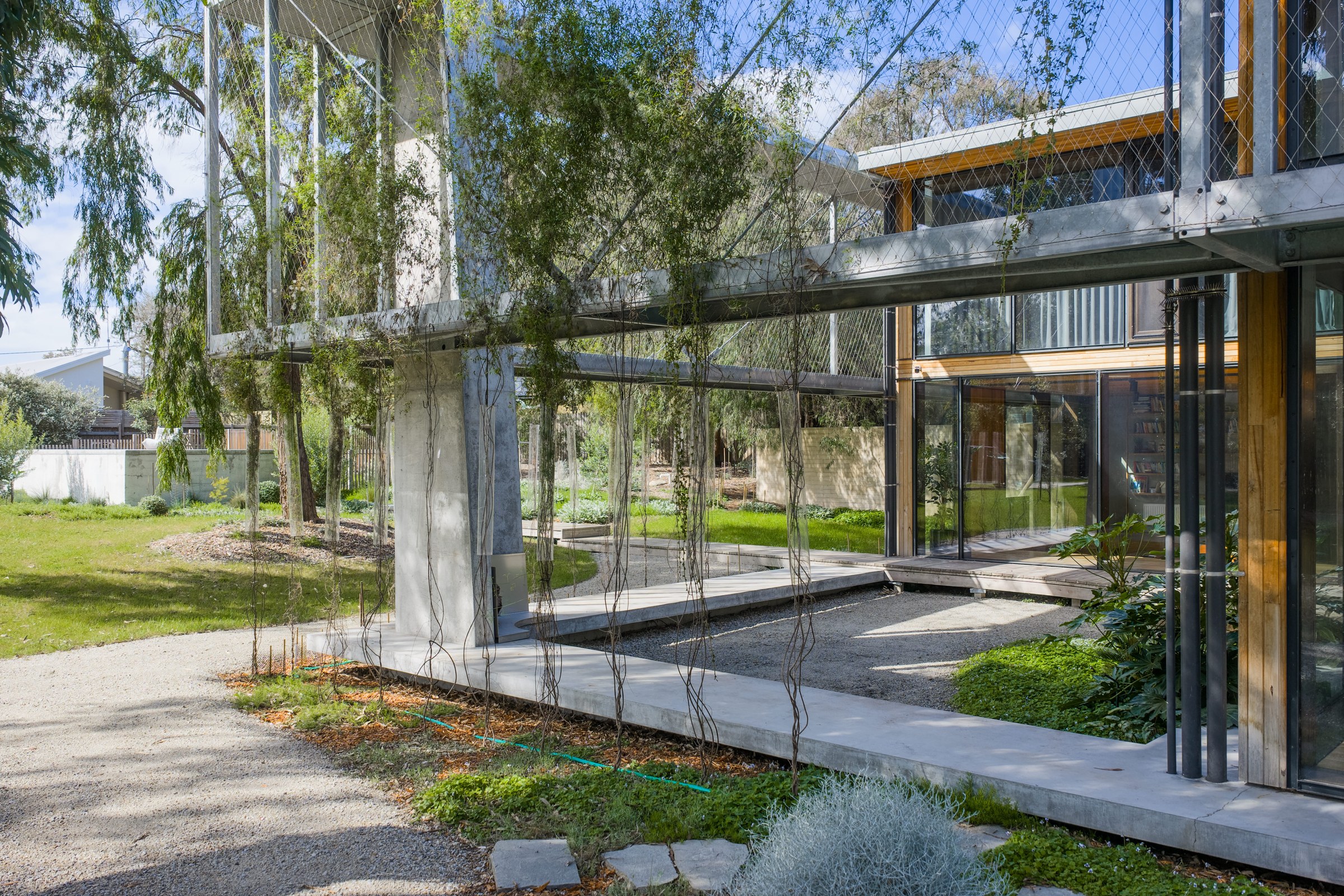 Upper walkway wrapping the central courtyard and glazed façade.