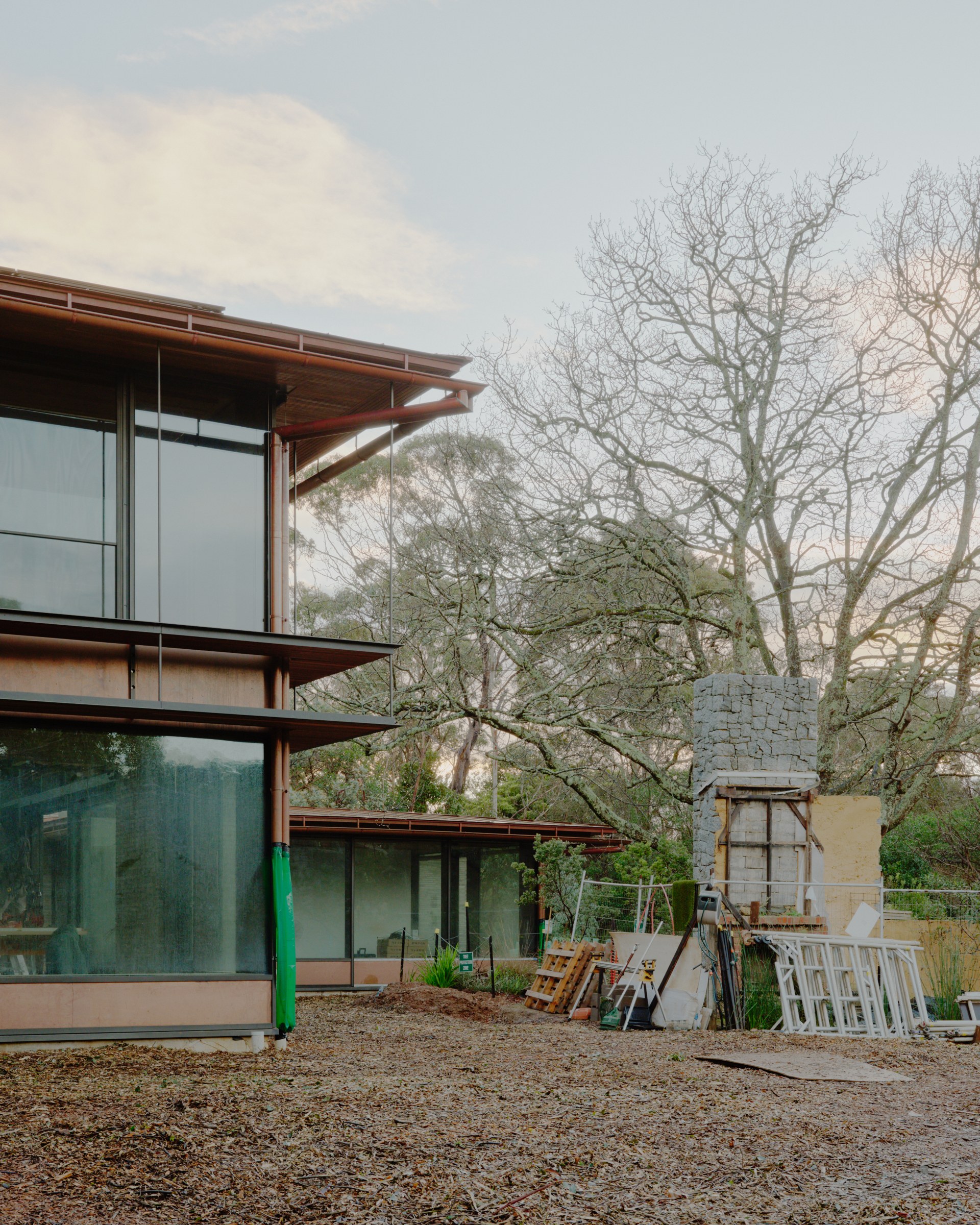 Two-storey timber-framed façade beside the garden at Anchor House during construction.