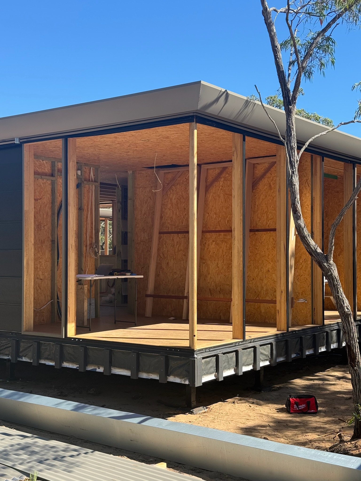 Timber façade framing and wall panels during assembly.