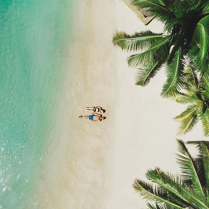 Aerial view of a couple lying on the beach