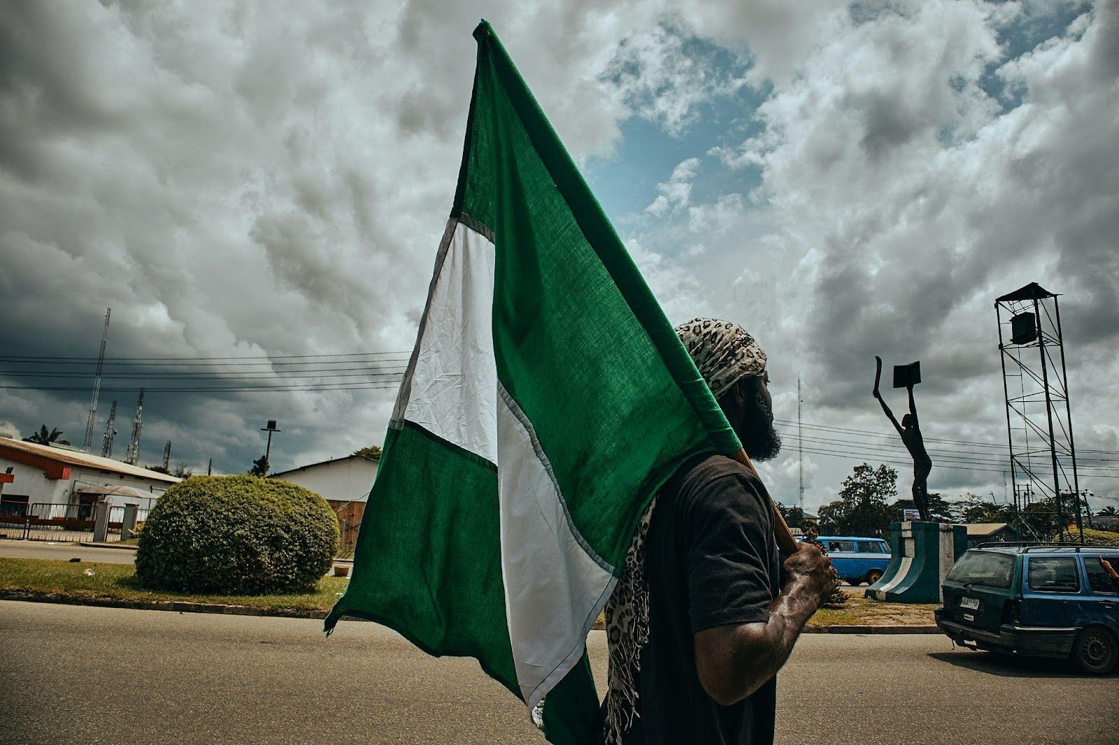 Man holding Green and white flag