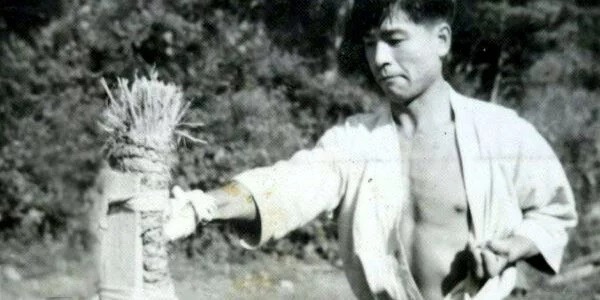 Karateka punching a makiwara