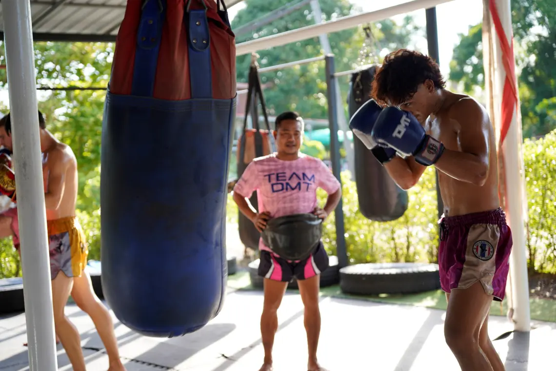 People of all ages training in a Muay Thai gym in Thailand
