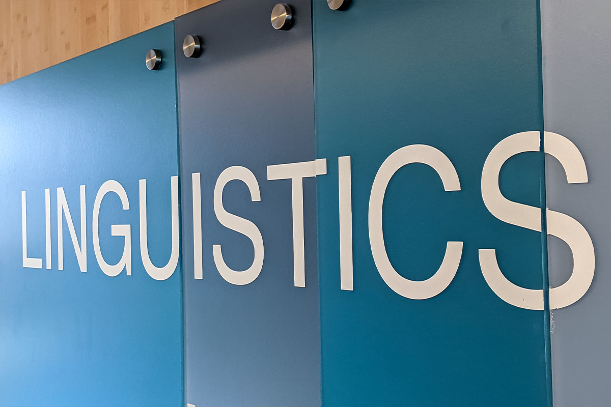 Wall panels with the word LINGUISTICS in large white letters on shades of blue background.