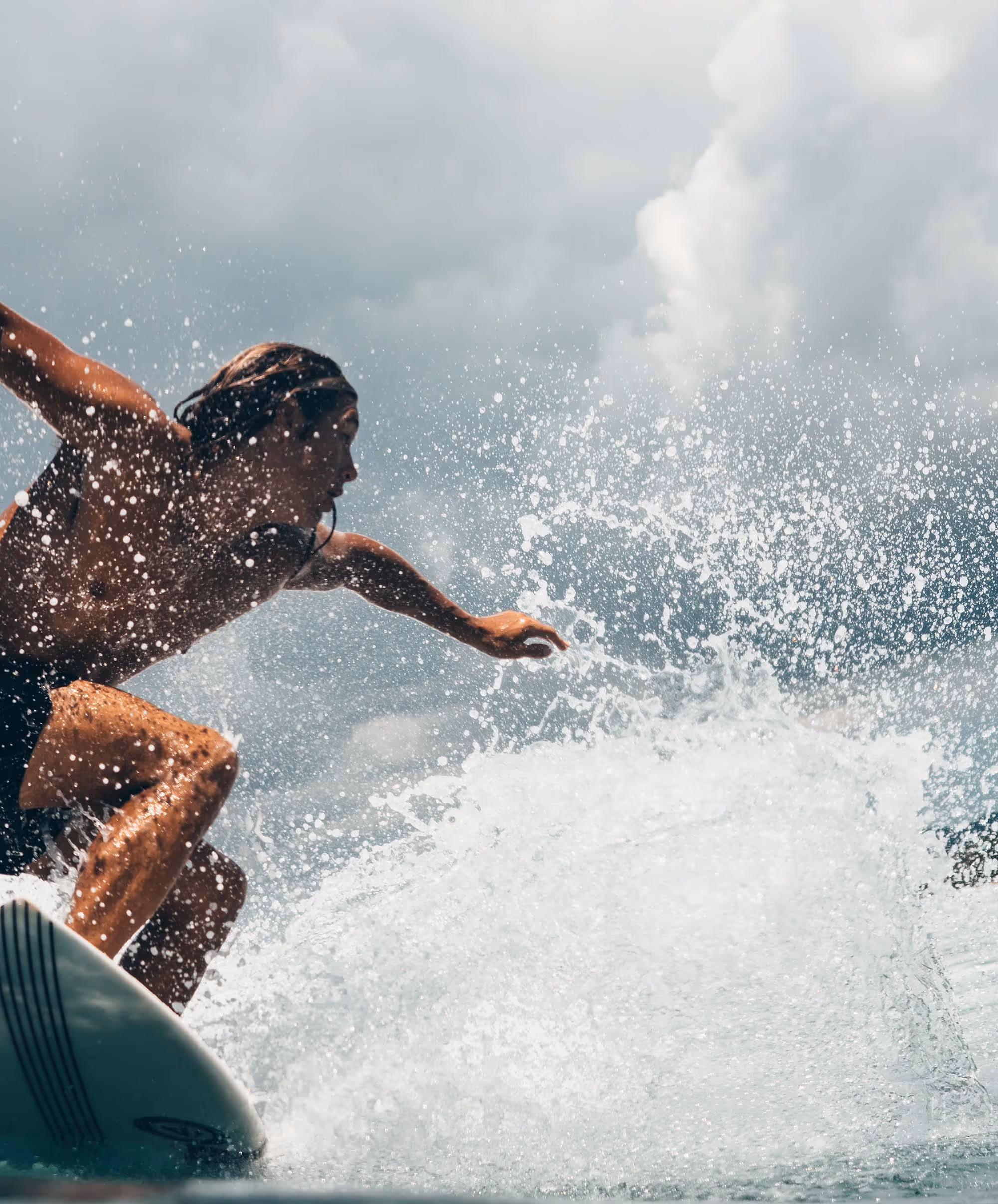 surfing girl surfing big wave in Nosara, Costa Rica