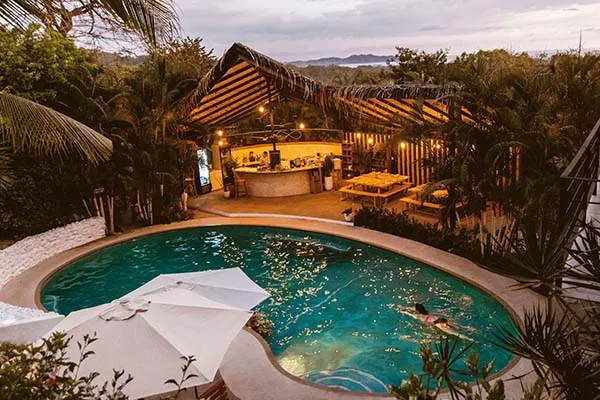 View of pool and bar at Casas Kismet at dusk