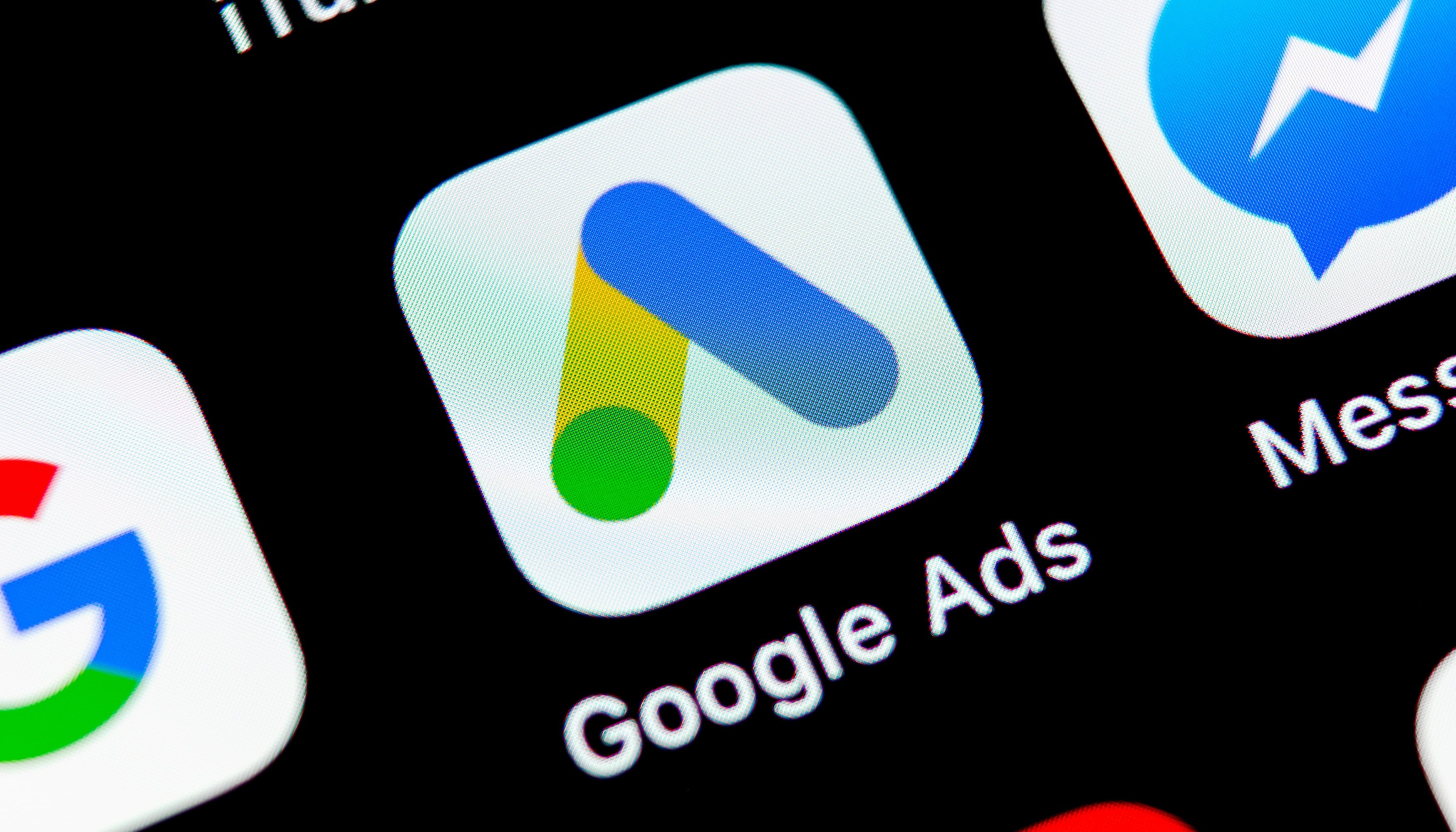 Close-up of a phone screen showing the Google Ads app icon next to Messenger