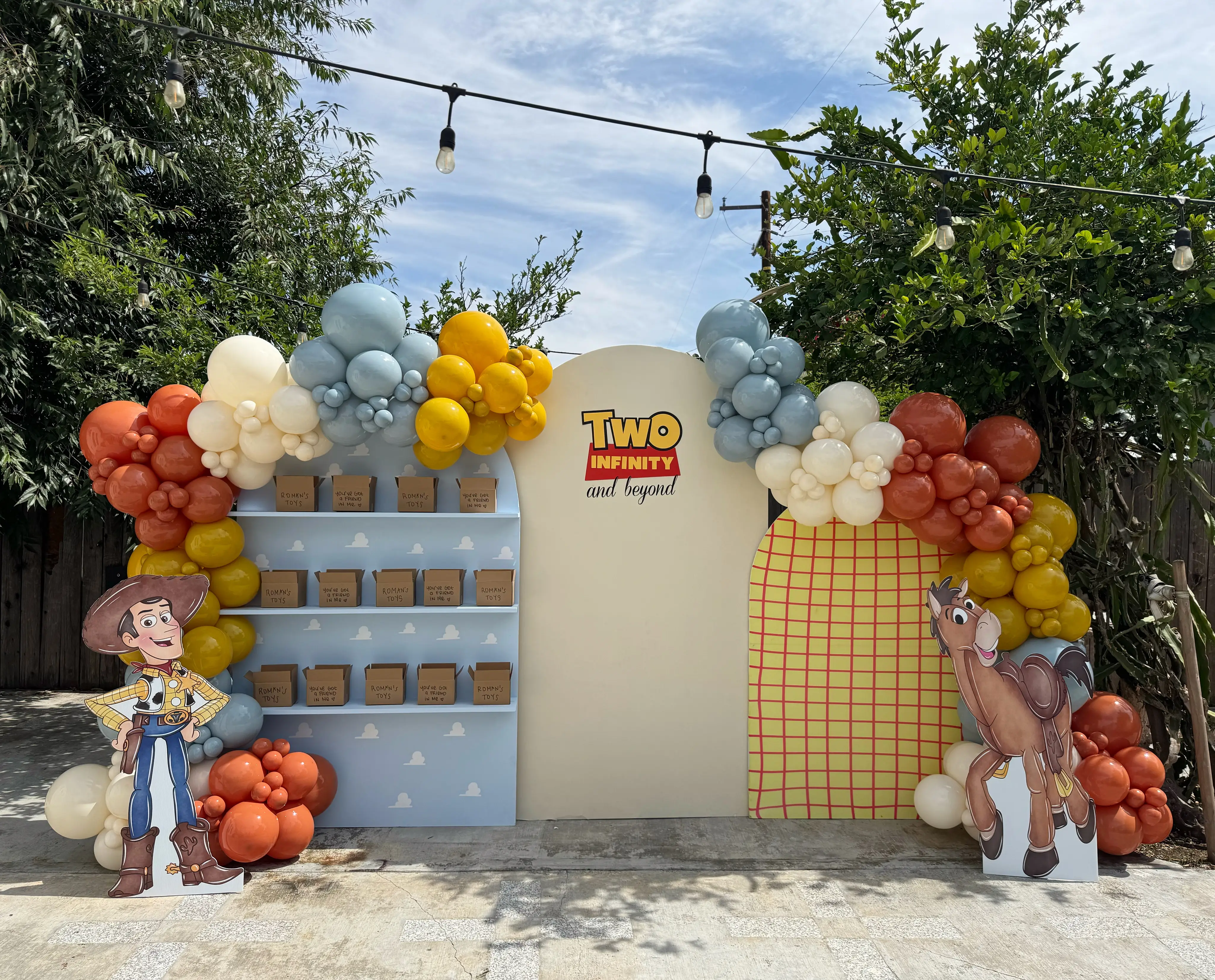 Toy Story themed kids birthday backdrop with balloon garland, custom decor and dessert display in Inland Empire