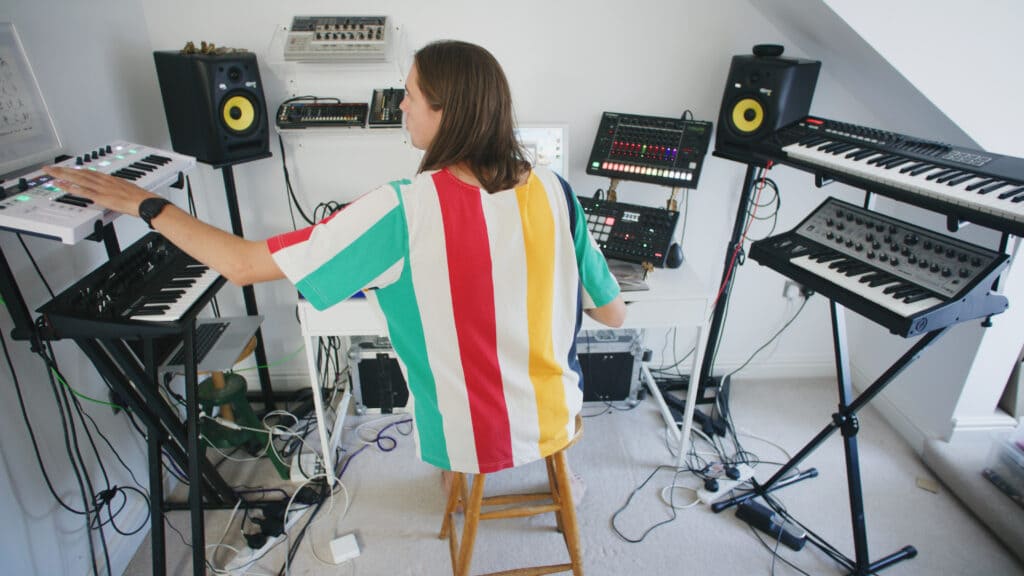 j03l press shot in the studio working on a beat