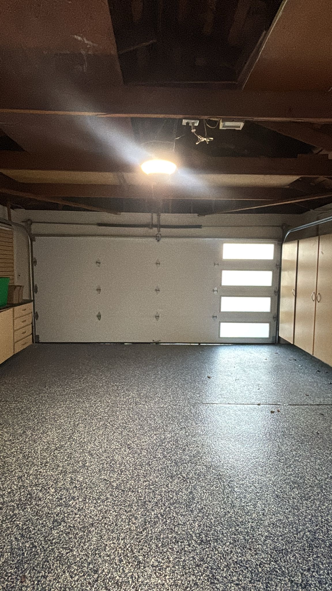 Clean, empty garage interior with a closed garage door.
