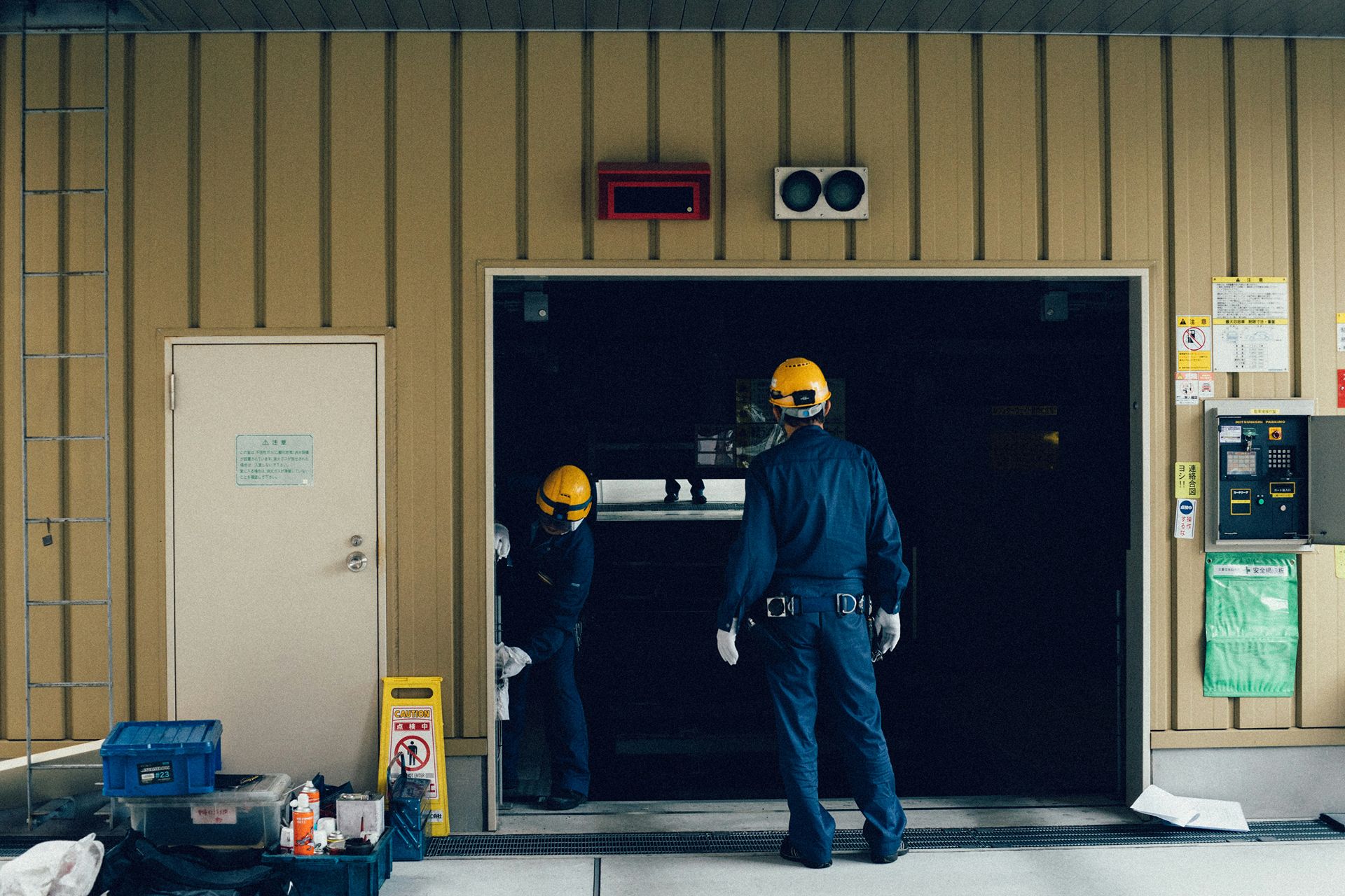 Technicians standing at a garage door