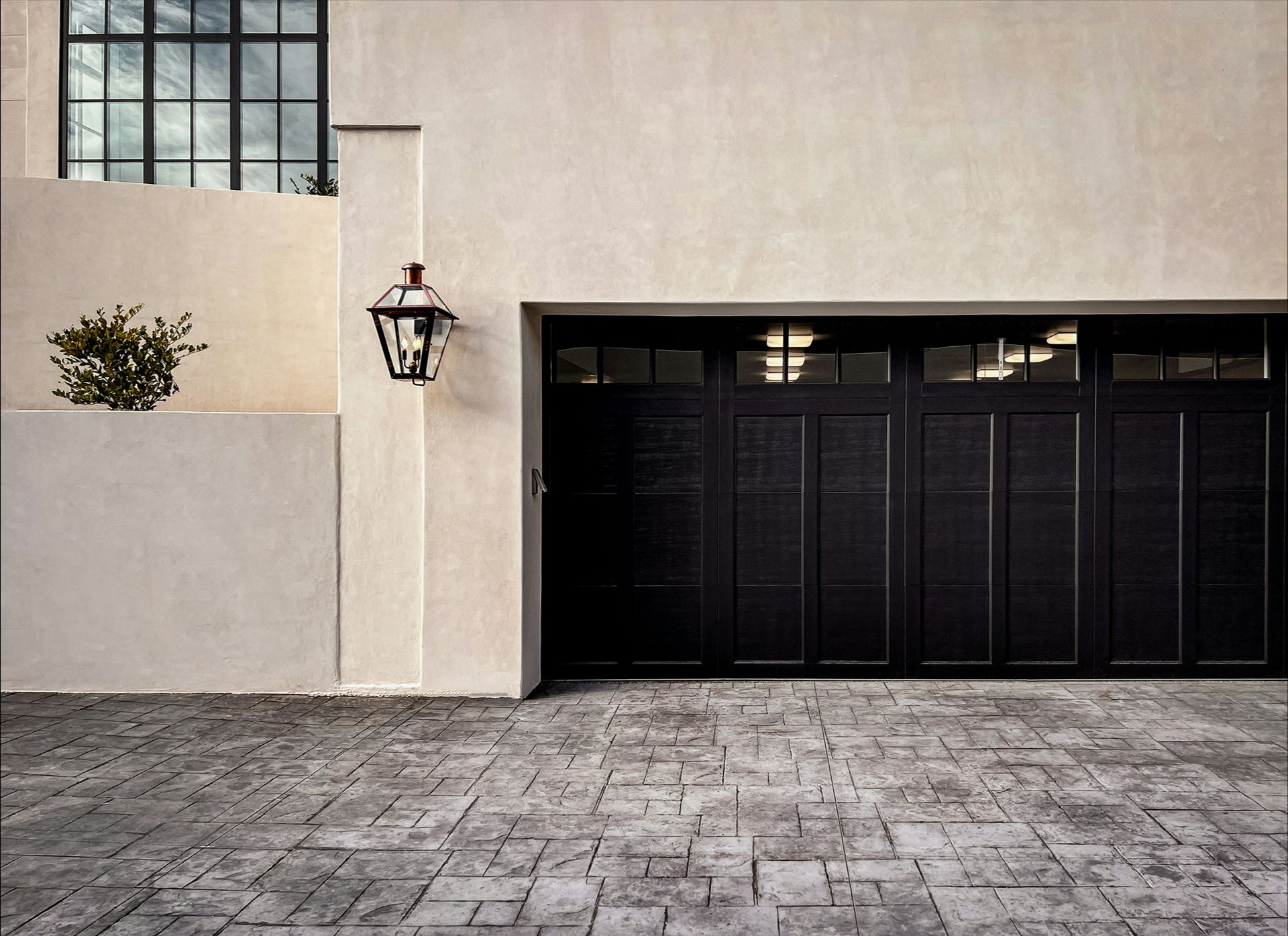 A residential building with a black garage door