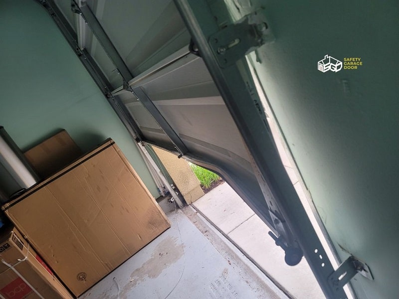 Damaged garage door panel causing the door not to close properly
