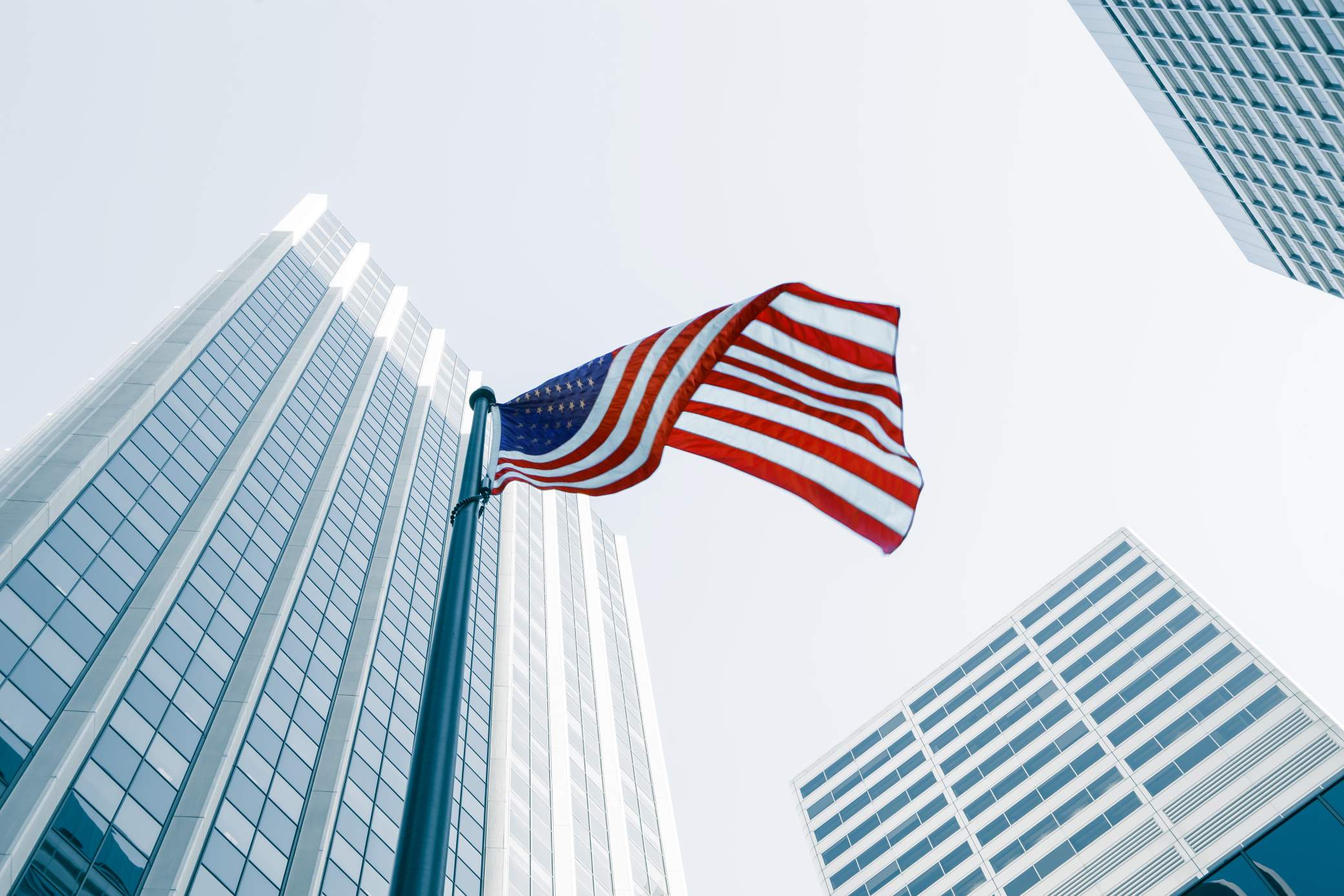 The US flag with skyscrapers in the background