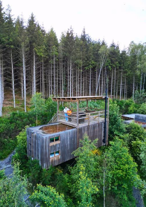 A couple on the rooftop terrace of a cabin in the woods in the Ardennes