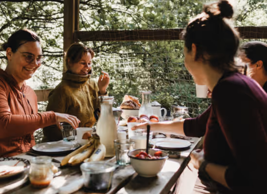 A group of girlfriends enjoying a meal during a unique weekend away with friends.