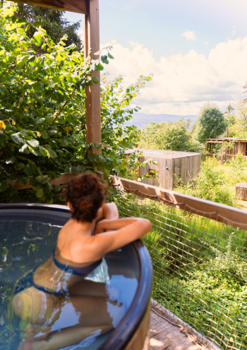 A Nutchel guest enjoying the hot tub of her cosy cabin thanks to a Nutchel promo code