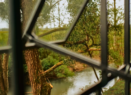 The Armance river, passing in front of a Soul cabin, a tiny house near Paris