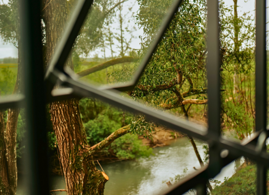 The Armance river, passing in front of a Soul cabin, a tiny house near Paris