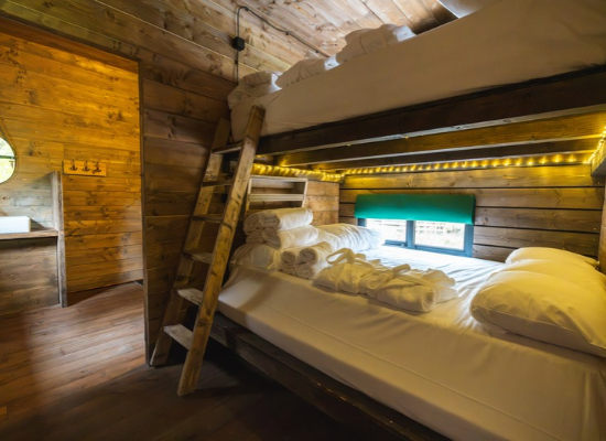 A bedroom with two double beds in a wooden cabin near Paris