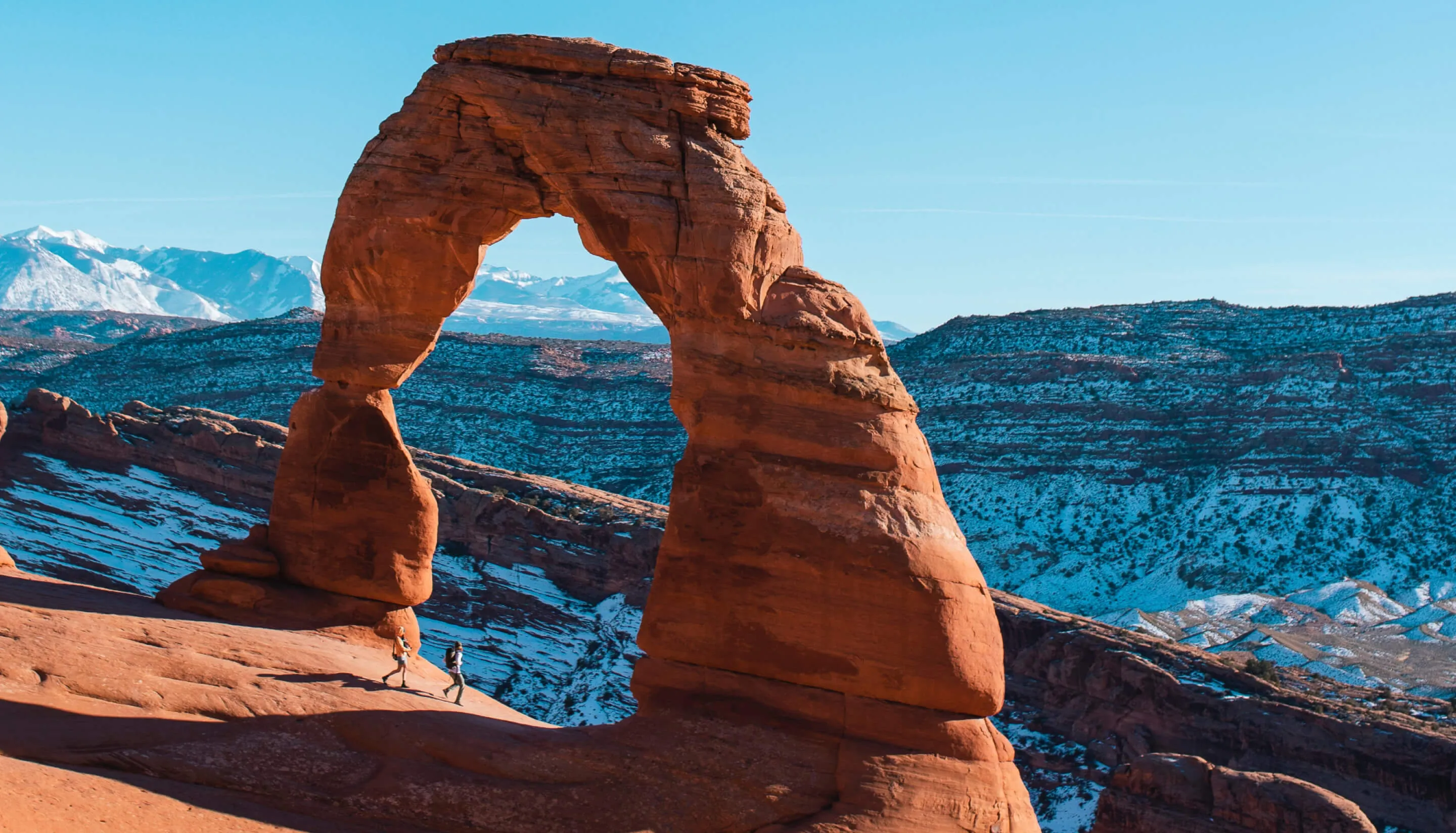 two people under rock and beautiful view