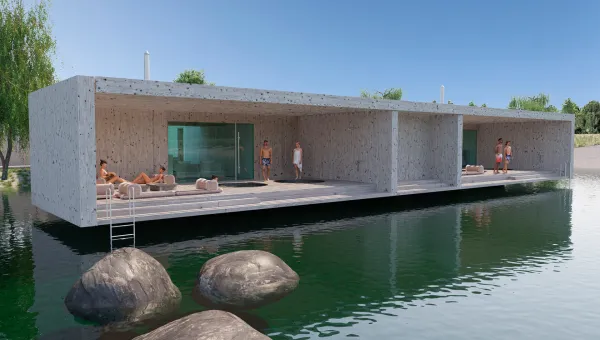 A group of people sitting on a dock next to a body of water.
