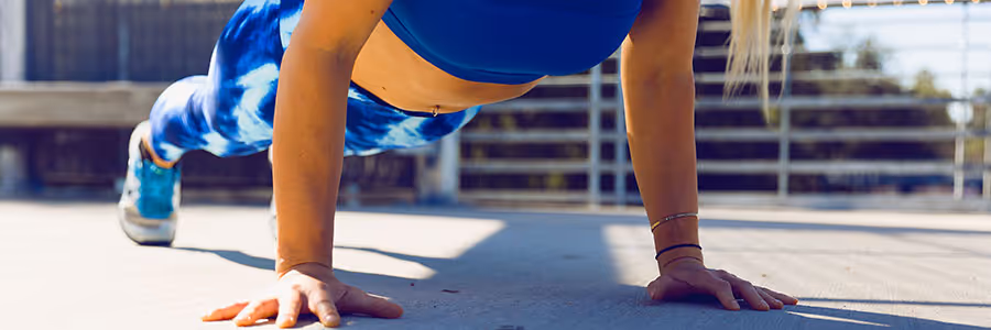 Women doing press ups outside