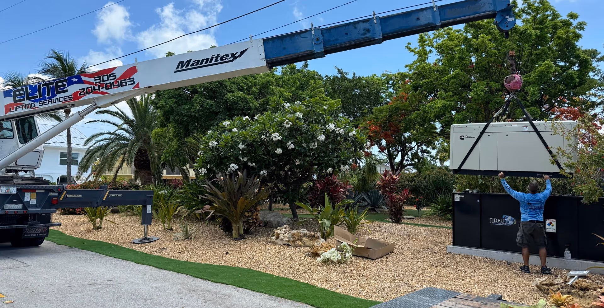 A crane lifts a Cummins generator onto it's base during an Islamorada Power generator installation in the Florida Keys.