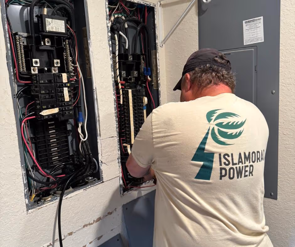 An Islamorada Power technician at work in front of a power panel during a generator maintenance call.
