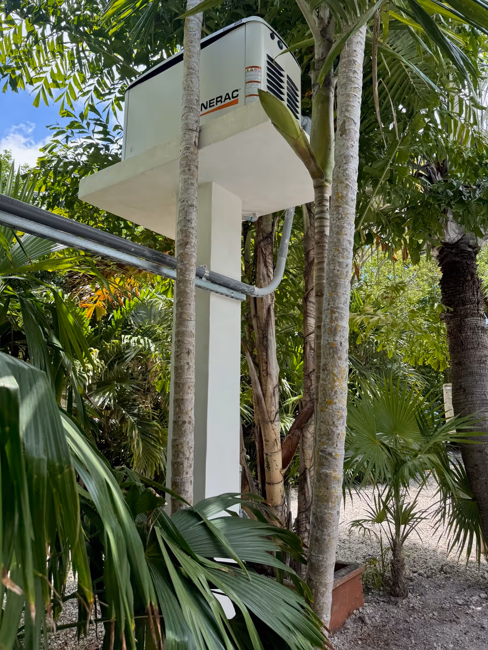 Generac generator mounted on elevated stand for flood protection in Plantation Key