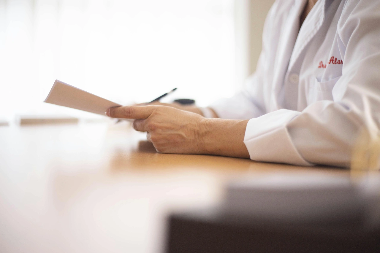 A doctor holding a clipboard and performing a diagnosis