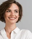 woman with a white blouse smiling