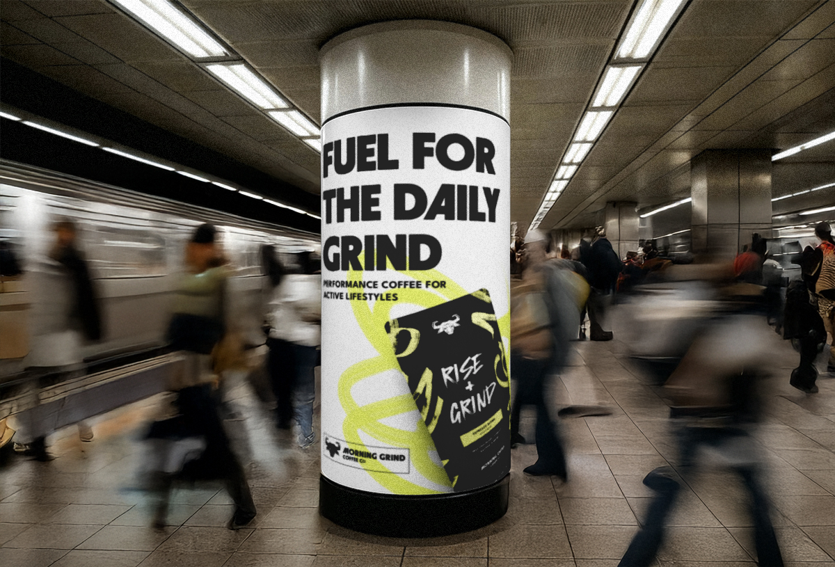A bustling subway station with a large concrete pillar in the center of the image. On the pillar is an ad for Morning Grind Coffee. It's a white poster that says Fuel For The Daily Grind Performance Coffee for Active Lifestyles. On the ad there is a black Rise+Grind coffee bag with a florescent yellow scribble behind it. 