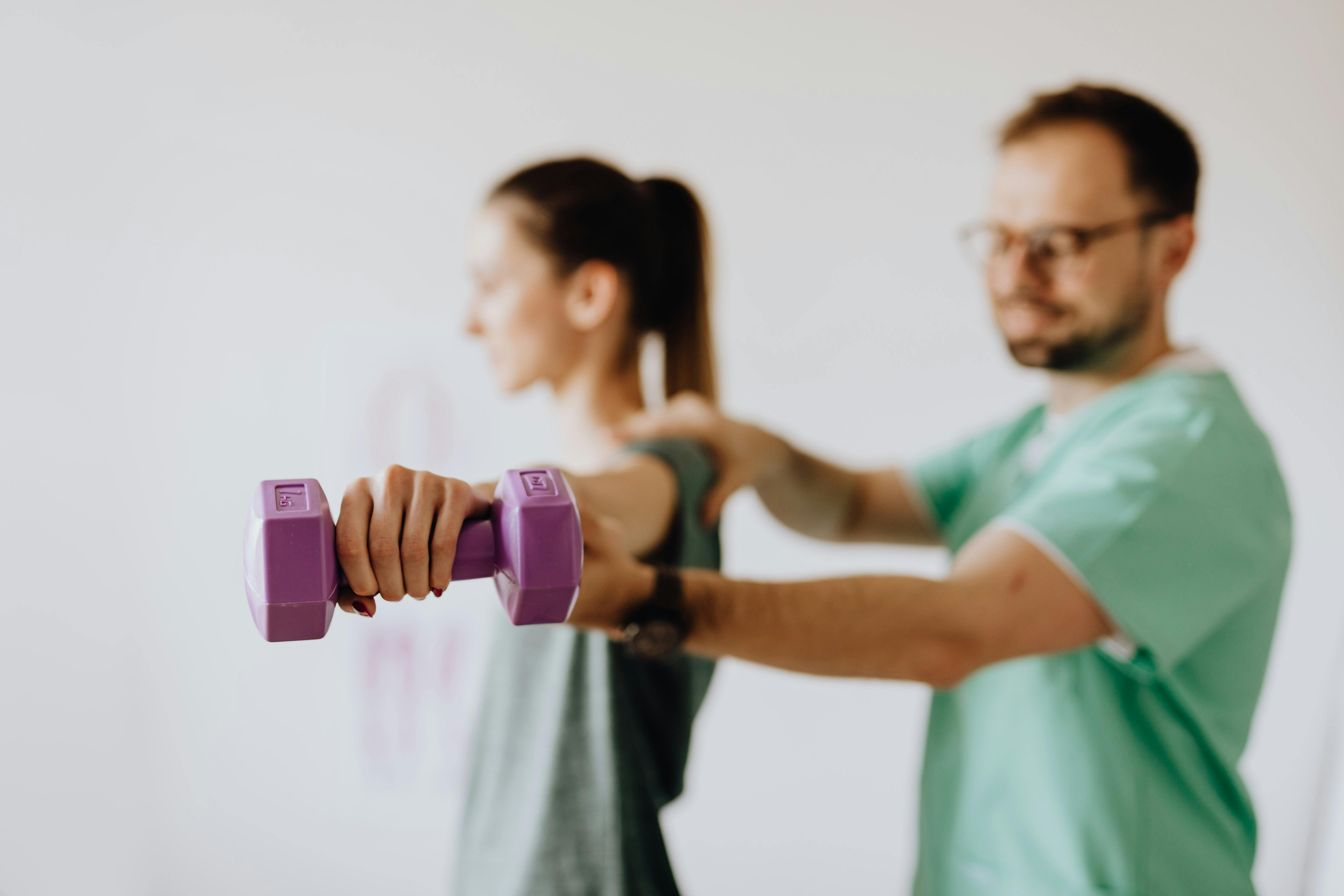 Man holding a hand of a woman for excercise