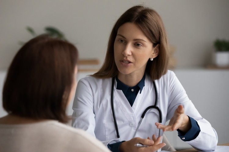 Healthcare professionals discussing patient care to emphasize ethics and improve patient outcomes.