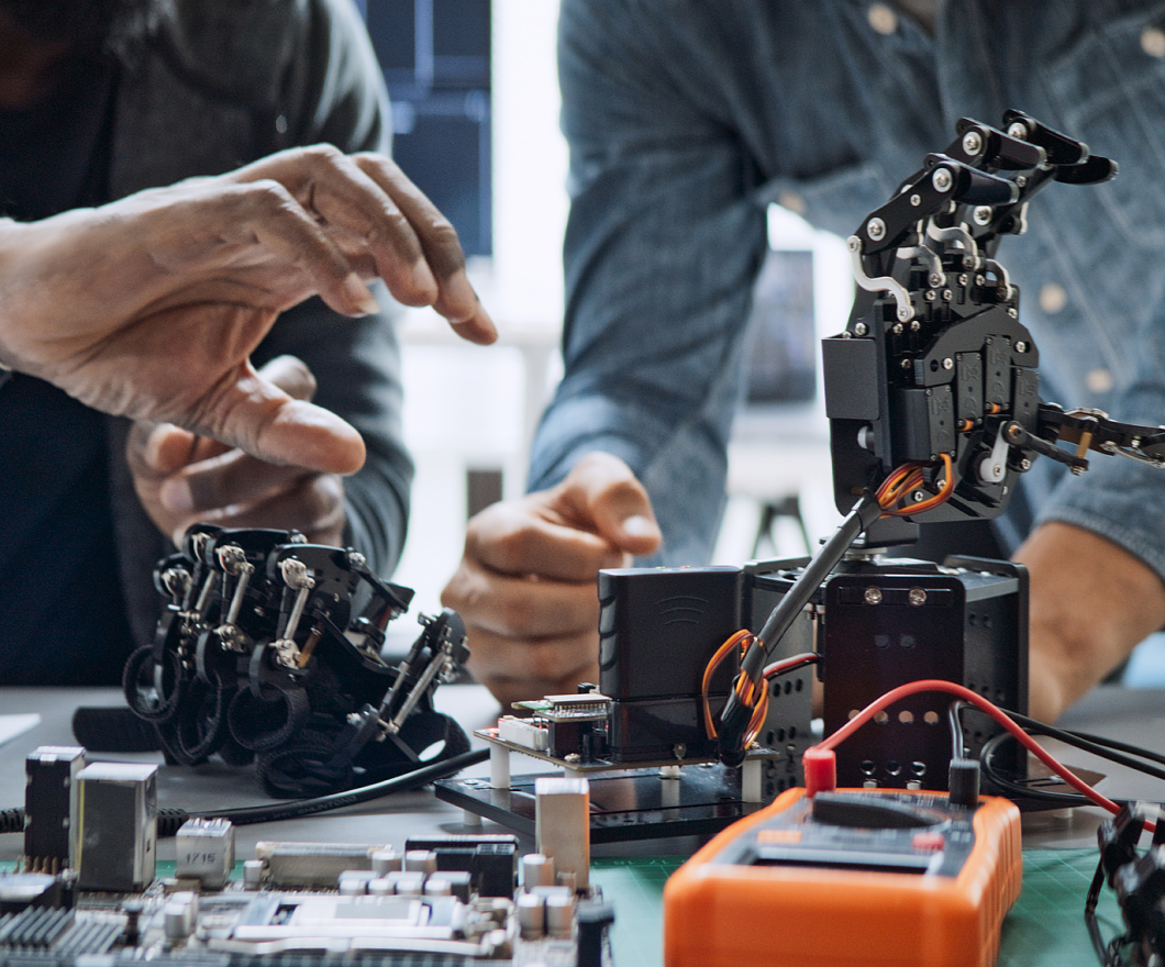worker using his hand to train a robotic hand