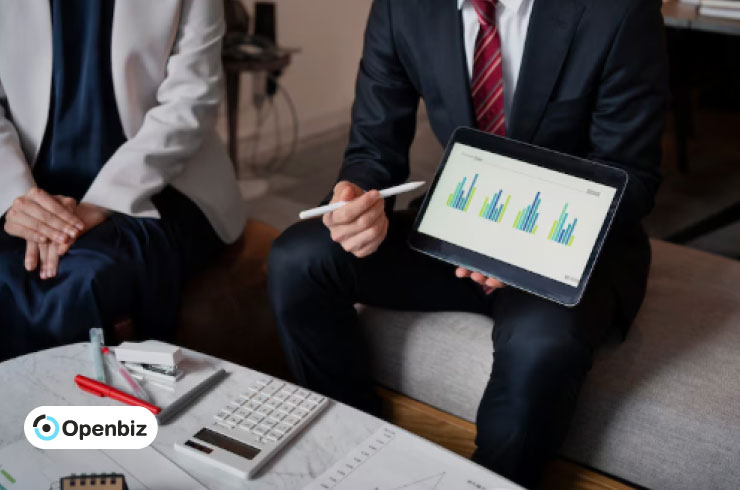Executives reviewing financial charts on a tablet during a meeting, illustrating balance sheet analysis.