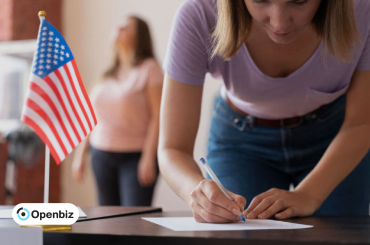 Woman signing a document in front of a U.S. flag, apostille process.