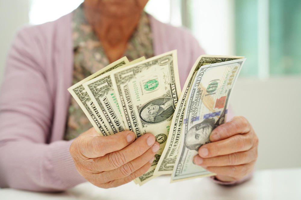 Individual reviewing cash earnings and evaluating financial transaction fees