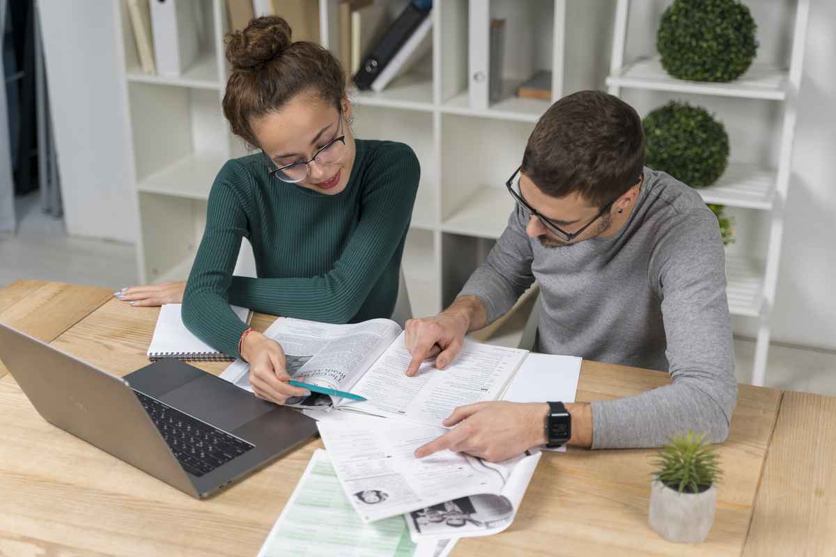 High-angle view of students studying financial assets together